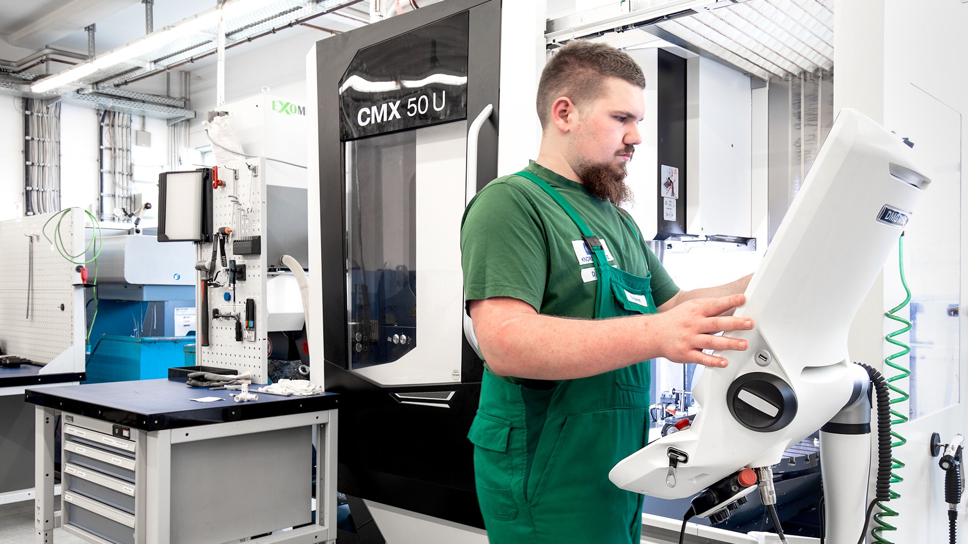 Dominik Bobon, an apprentice at Knorr-Bremse in Berlin, in front of a machine control screen.