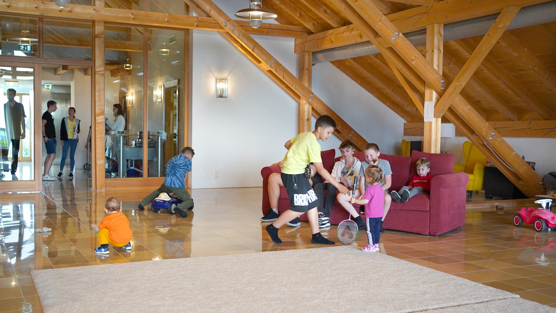 Ukrainian children of different ages play in a room specially set up as a living room and playroom.