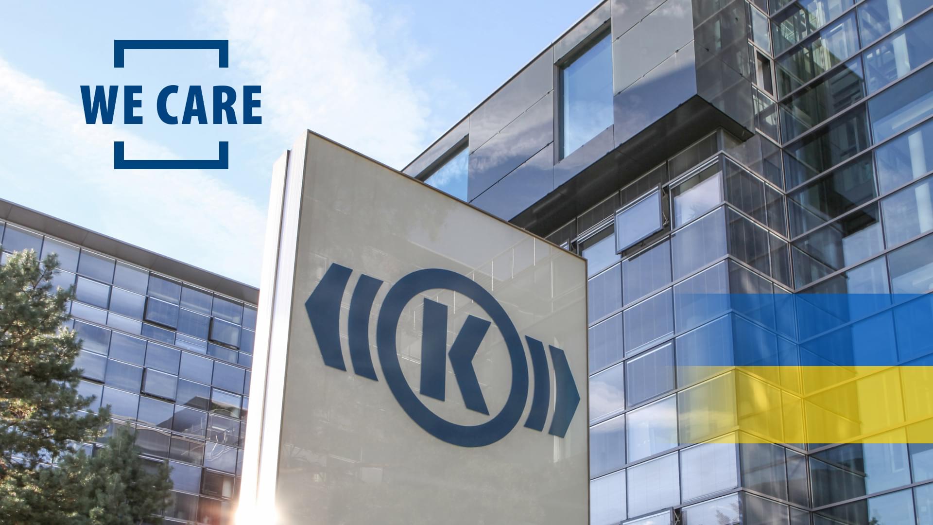 Photo of a Knorr-Bremse building at the company headquarters in Munich, on which the words "We Care" and a Ukrainian flag have been graphically placed.