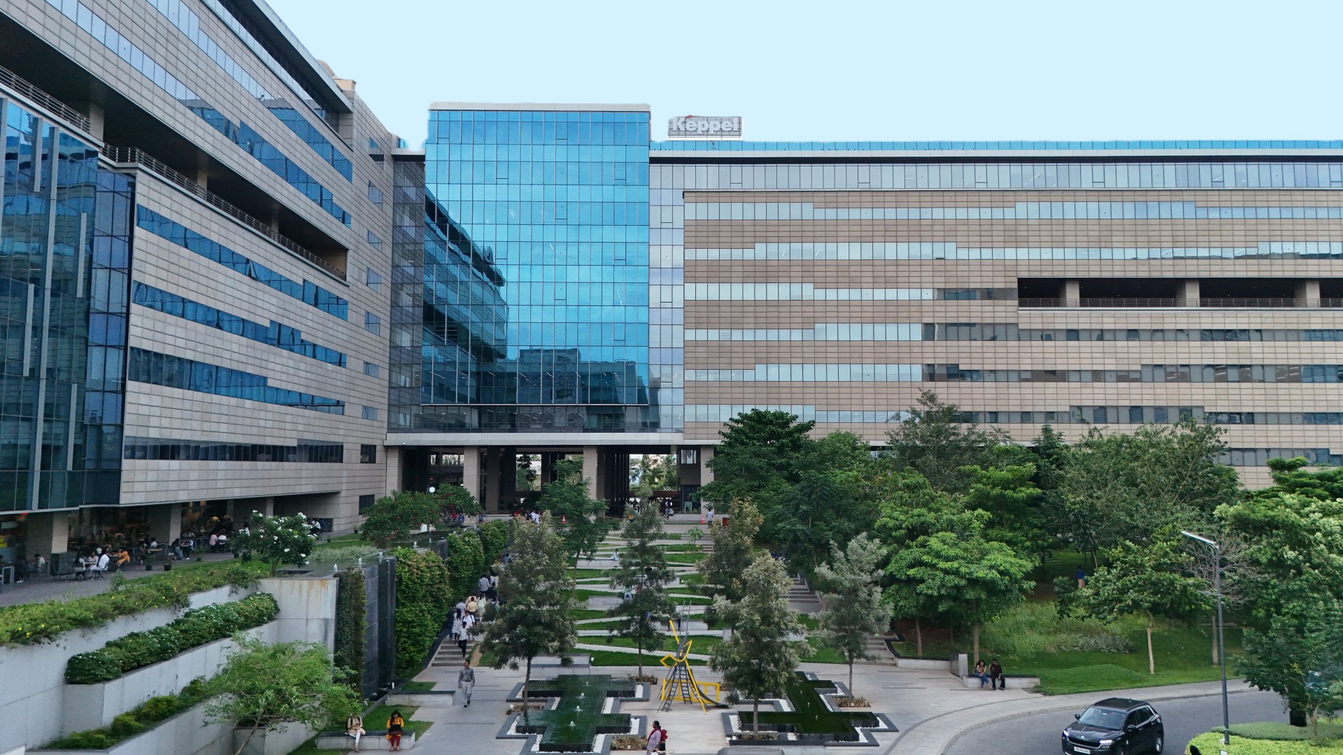 Knorr-Bremse’s globales KI-Zentrum in Chennai, Indien – moderne Bürogebäude mit Glasfassade und begrüntem Innenhof. Investition in Künstliche Intelligenz für digitale Transformation und Prozessoptimierung.