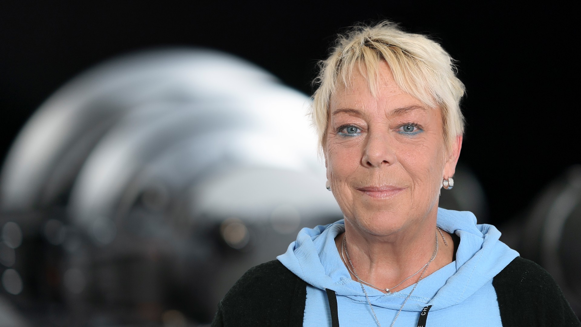 Business‑Portrait eines Aufsichtsratsmitglieds der Knorr‑Bremse AG vor industrieller Maschinenkomponente