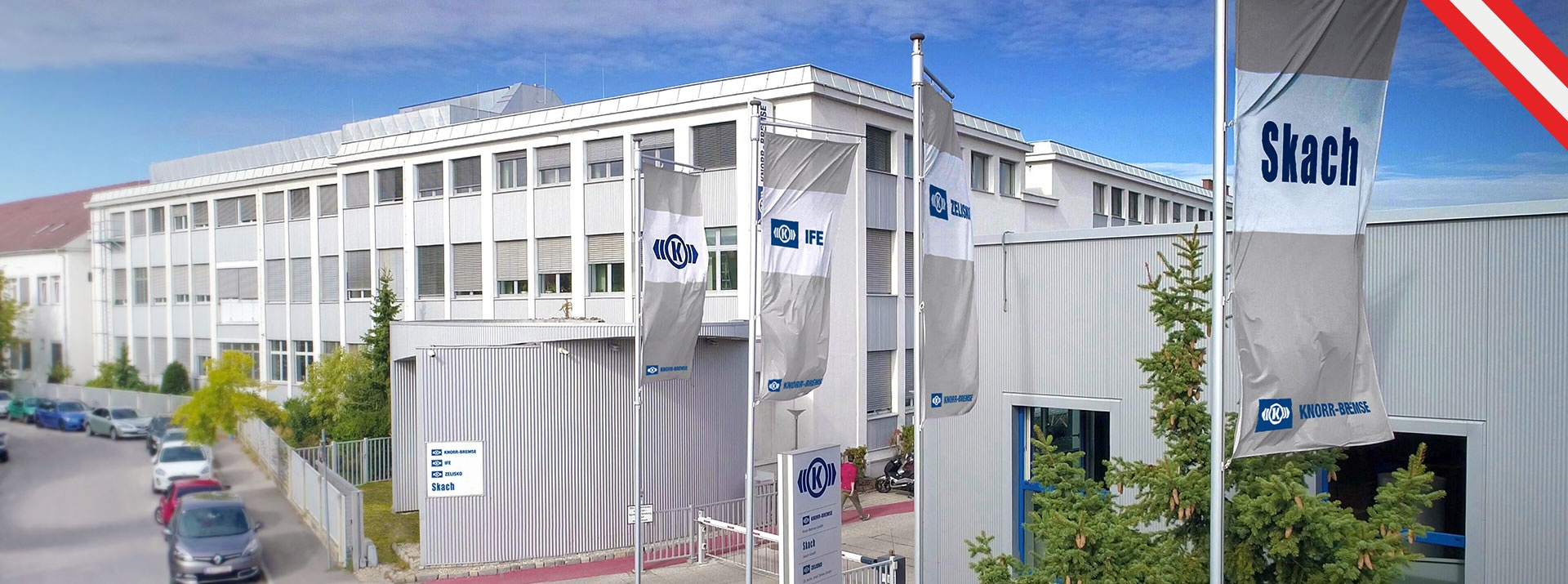 Building with logo flags in the foreground of the Austrian Knorr-Bremse site in Mödling
