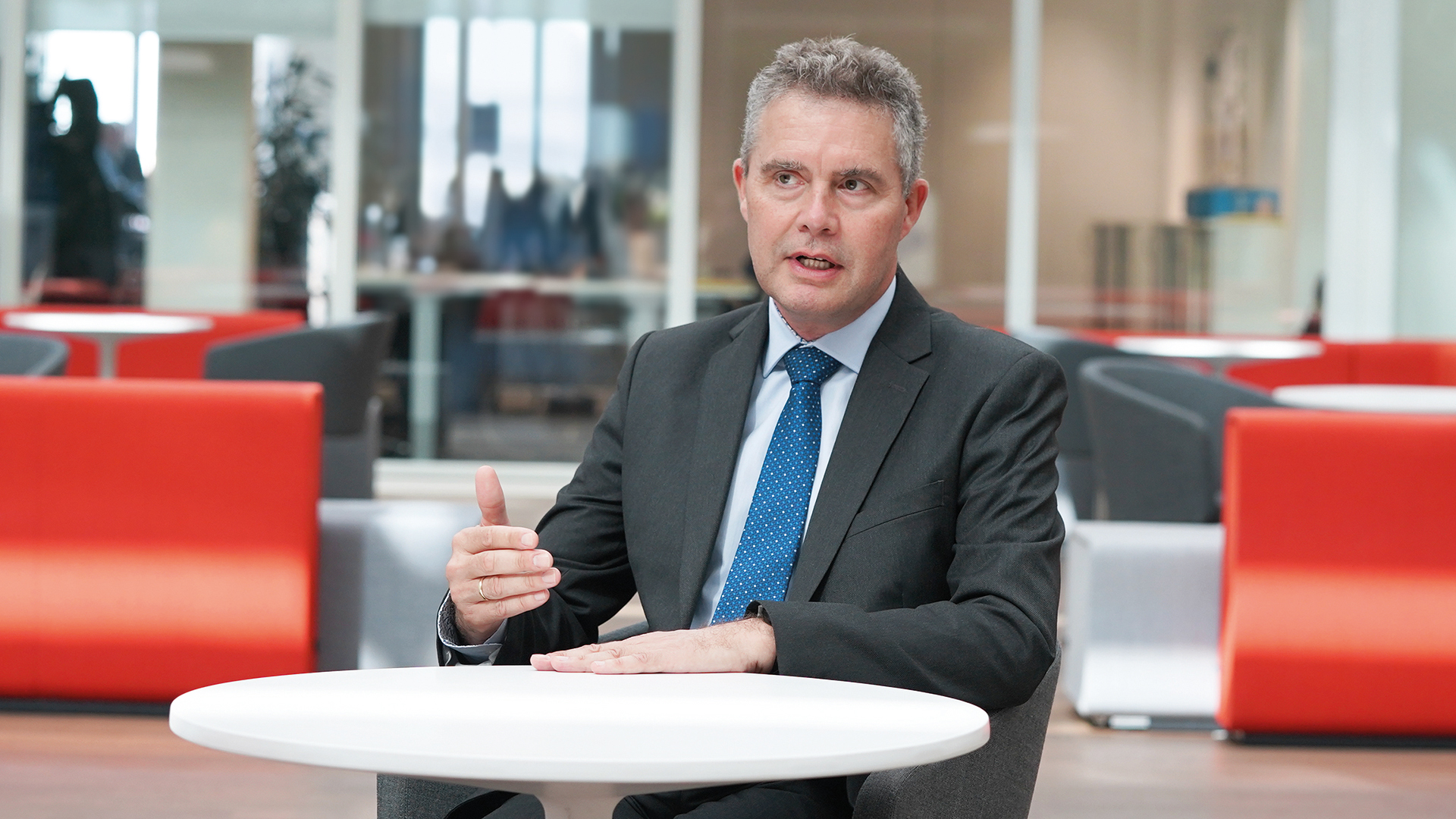 Dr. Jonathan Paddison, Member of the Executive Board of Knorr-Bremse Asia Pacific, based in Hong Kong, China, sits in the lounge area at the company's headquarters in Munich and answers interview questions.