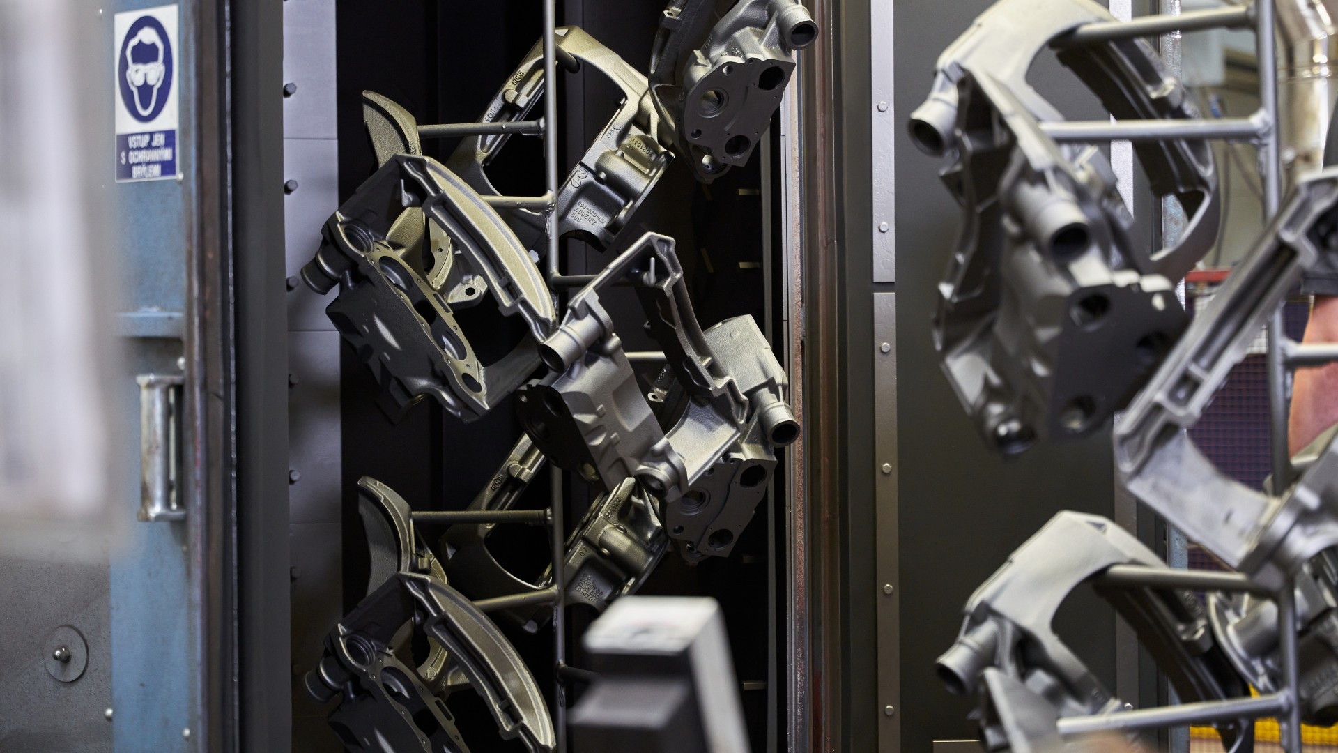 Mechanical commercial vehicle components after surface treatment, suspended on carriers, at the Knorr‑Bremse remanufacturing plant in Liberec