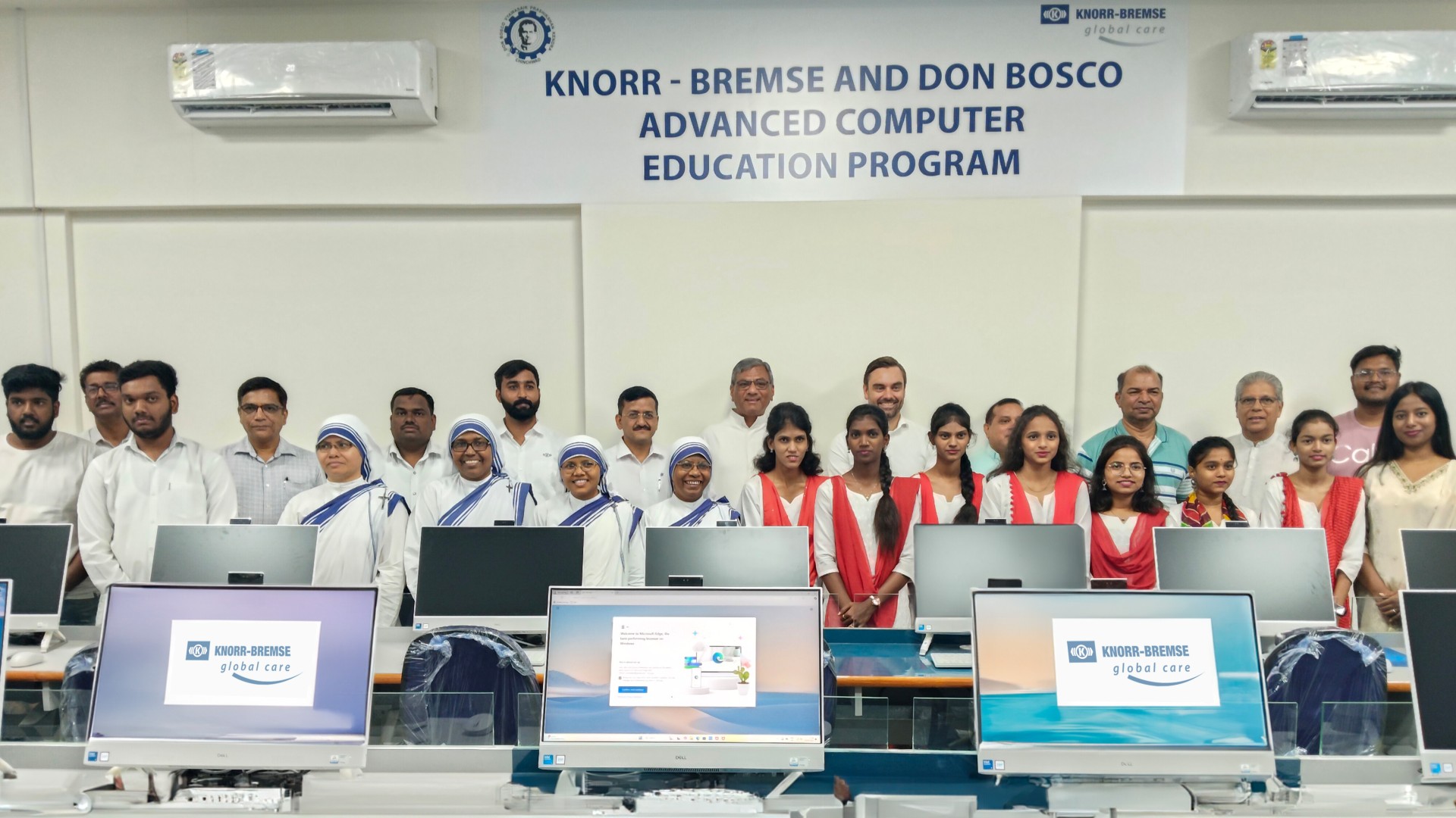 Computer training room of the Advanced Computer Education Program by Knorr‑Bremse and the Don Bosco Technical Training Institute in Pune, with participants in the background
