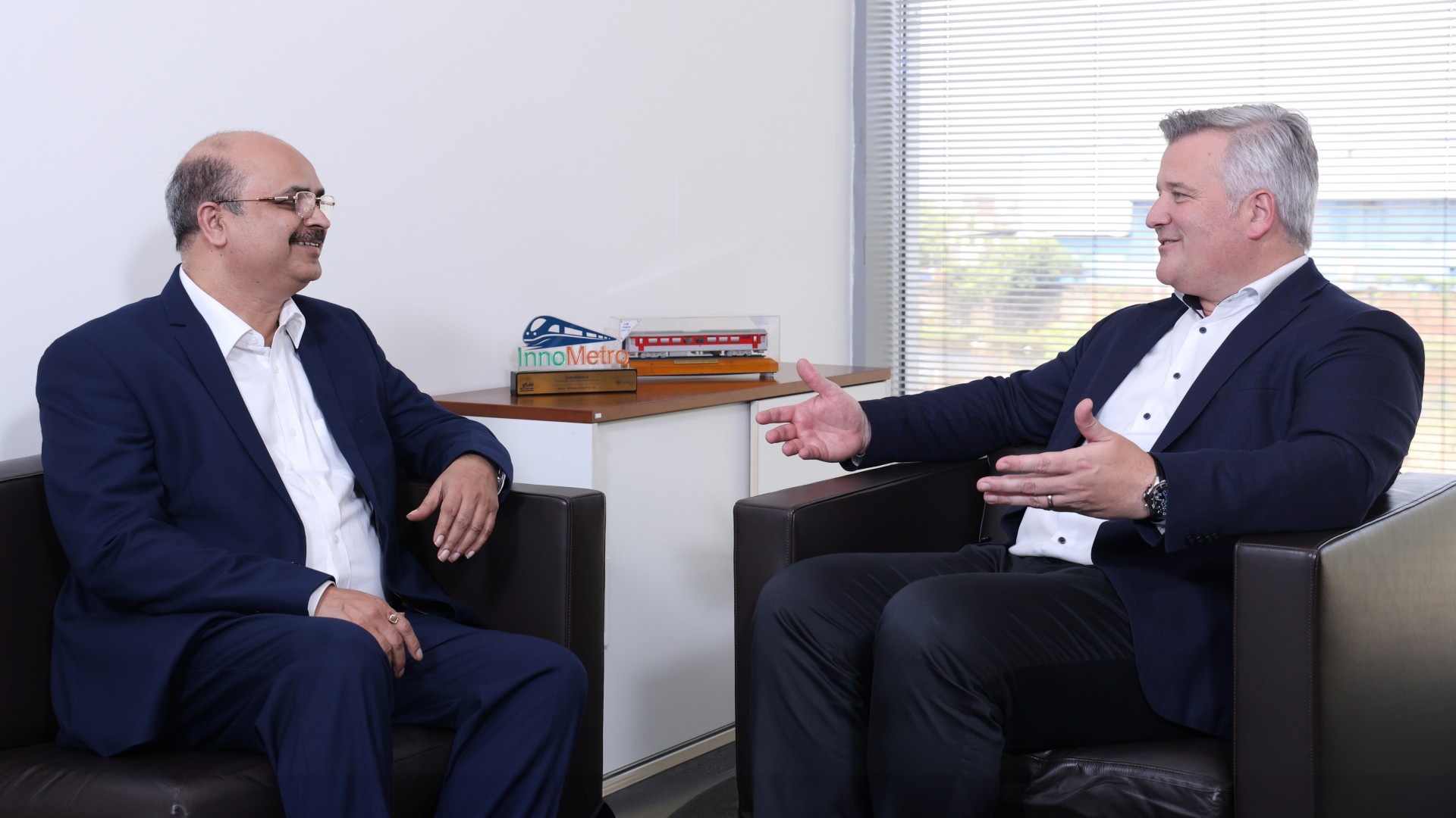 Two senior leaders from Knorr‑Bremse Rail in discussion about strategies, systems, and opportunities in the Indian rail market
