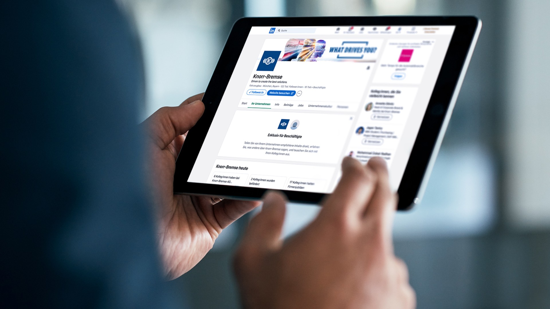 Hands holding a tablet displaying the Knorr‑Bremse LinkedIn company profile